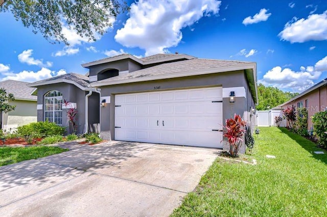 31349 Philmar Ln, Wesley Chapel, FL 33543 - ranch-style home featuring stucco siding, an attached garage, and concrete driveway