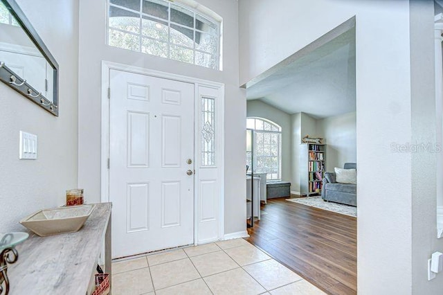 31349 Philmar Ln, Wesley Chapel, FL 33543 - entryway featuring light tile patterned flooring and a towering ceiling