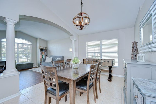 31349 Philmar Ln, Wesley Chapel, FL 33543 - dining space featuring lofted ceiling, ornate columns, arched walkways, and light tile patterned floors