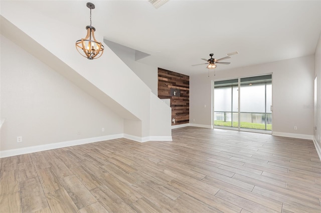 10966 Winter Crest Dr, Riverview, FL 33569 - unfurnished living room featuring a ceiling fan, a chandelier, and light wood-style floors