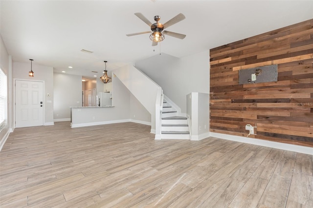 10966 Winter Crest Dr, Riverview, FL 33569 - unfurnished living room featuring light wood-type flooring, stairs, ceiling fan, wood walls, and recessed lighting