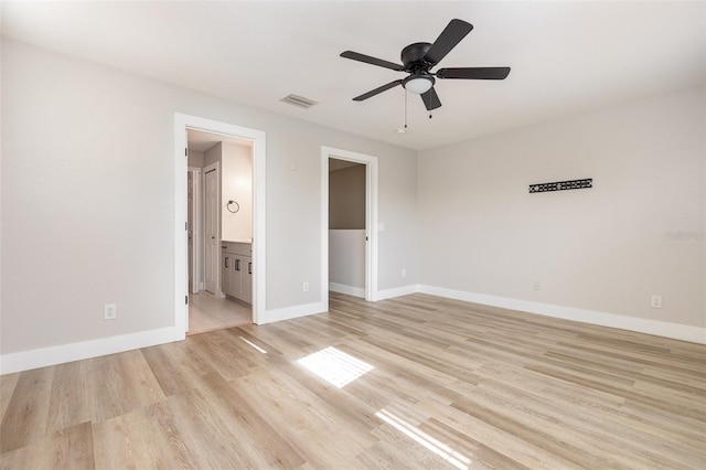 10966 Winter Crest Dr, Riverview, FL 33569 - unfurnished bedroom featuring light wood-style floors, ensuite bath, ceiling fan, and a walk in closet
