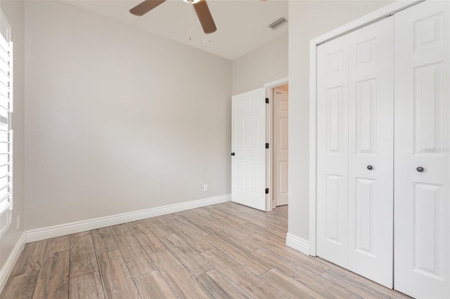 10966 Winter Crest Dr, Riverview, FL 33569 - unfurnished bedroom with light wood-style flooring, a closet, and ceiling fan