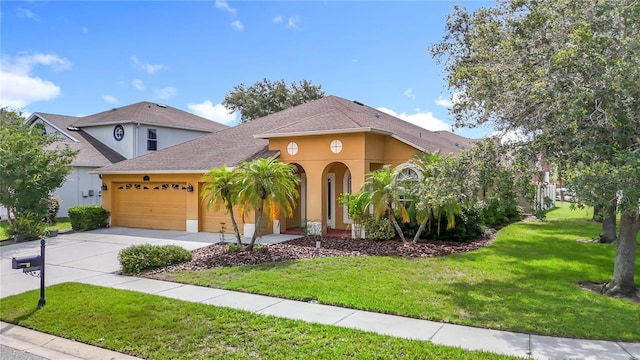 3824 Duke Firth St, Land O Lakes, FL 34638 - view of front of house with stucco siding, an attached garage, concrete driveway, a front yard, and roof with shingles