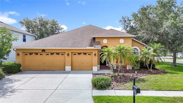 3824 Duke Firth St, Land O Lakes, FL 34638 - view of front facade with stucco siding, an attached garage, concrete driveway, and roof with shingles