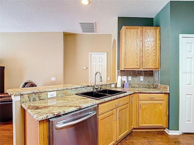 3824 Duke Firth St, Land O Lakes, FL 34638 - kitchen with stainless steel dishwasher, a peninsula, wood finished floors, light stone counters, and a textured ceiling