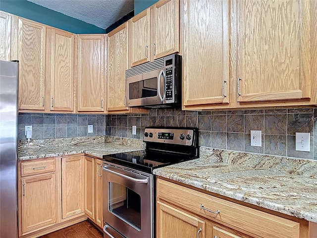 3824 Duke Firth St, Land O Lakes, FL 34638 - kitchen with stainless steel appliances, light brown cabinets, tasteful backsplash, light stone countertops, and a textured ceiling