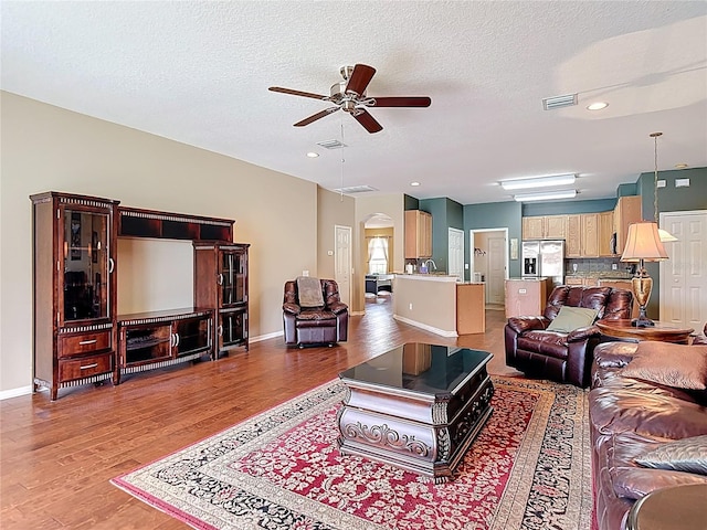 3824 Duke Firth St, Land O Lakes, FL 34638 - living room featuring ceiling fan, wood finished floors, arched walkways, a textured ceiling, and recessed lighting