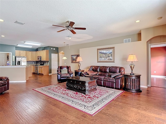 3824 Duke Firth St, Land O Lakes, FL 34638 - living area featuring a ceiling fan, dark wood-style floors, recessed lighting, and a textured ceiling