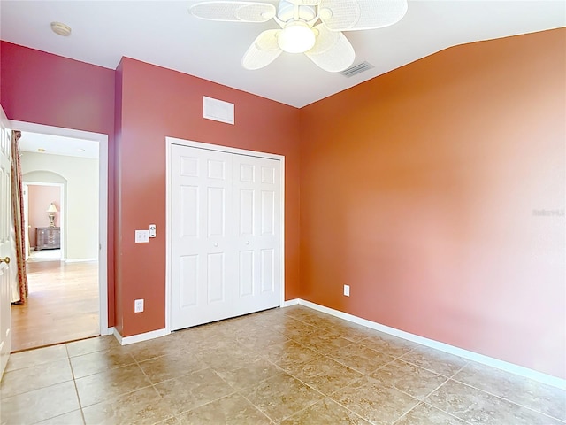 3824 Duke Firth St, Land O Lakes, FL 34638 - unfurnished bedroom with arched walkways, light tile patterned floors, lofted ceiling, a closet, and ceiling fan
