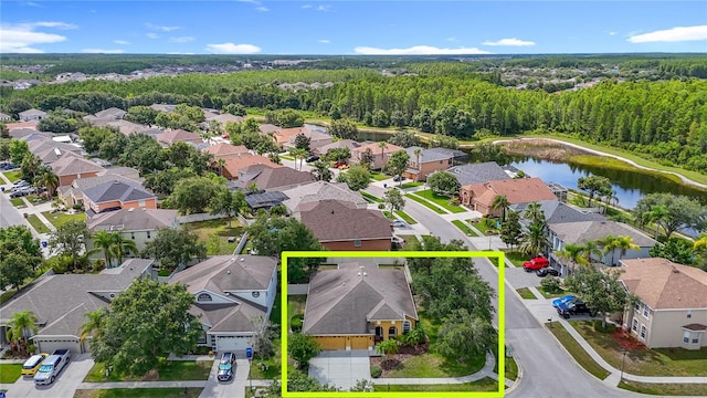 3824 Duke Firth St, Land O Lakes, FL 34638 - aerial perspective of suburban area featuring property parcel outlined and a heavily wooded area