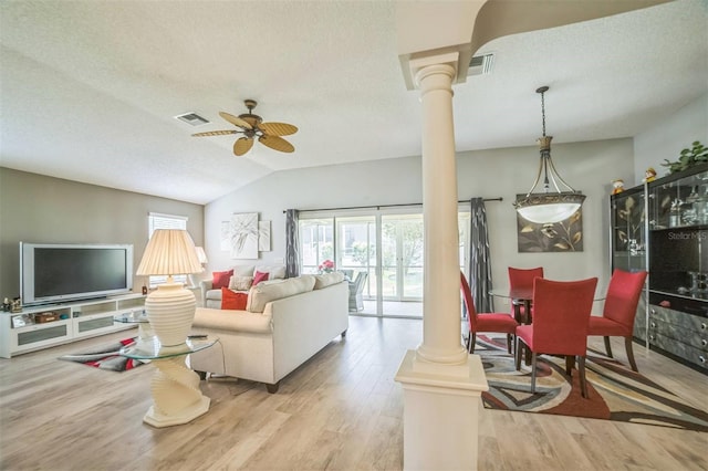 17567 SE 81st Parnassus Ct, The Villages, FL 32162 - living area with ornate columns, wood finished floors, ceiling fan, a textured ceiling, and vaulted ceiling