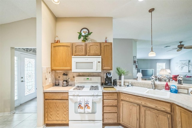 17567 SE 81st Parnassus Ct, The Villages, FL 32162 - kitchen featuring white appliances, a sink, tasteful backsplash, open floor plan, and light tile patterned flooring