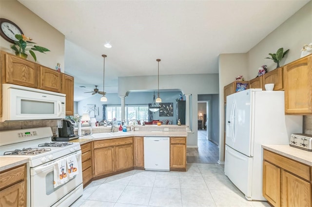 17567 SE 81st Parnassus Ct, The Villages, FL 32162 - kitchen featuring white appliances, a sink, light countertops, and a peninsula