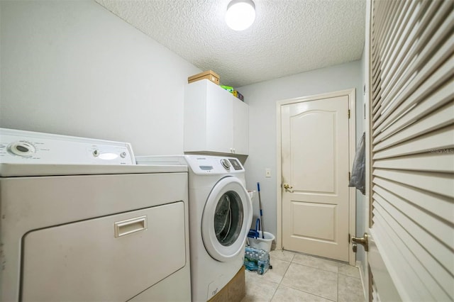 17567 SE 81st Parnassus Ct, The Villages, FL 32162 - laundry room featuring independent washer and dryer, cabinet space, a textured ceiling, and light tile patterned flooring