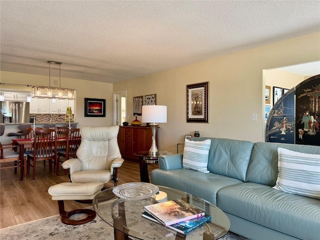 100 Bluff View Dr Unit 115C, Belleair Bluffs, FL 33770 - living room with light wood-type flooring and a textured ceiling