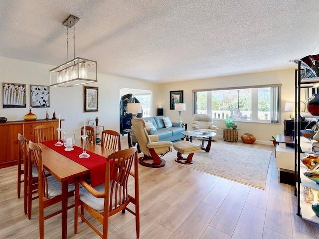 100 Bluff View Dr Unit 115C, Belleair Bluffs, FL 33770 - dining area featuring a textured ceiling and light wood-type flooring