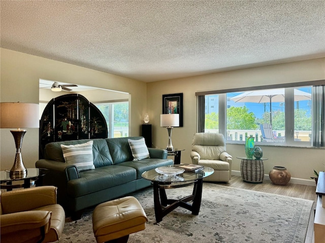100 Bluff View Dr Unit 115C, Belleair Bluffs, FL 33770 - living area featuring wood finished floors, a textured ceiling, and a ceiling fan