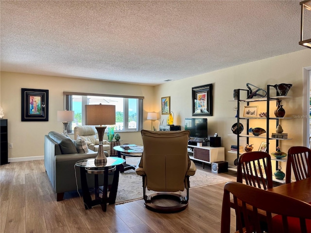 100 Bluff View Dr Unit 115C, Belleair Bluffs, FL 33770 - living room featuring a textured ceiling and wood finished floors