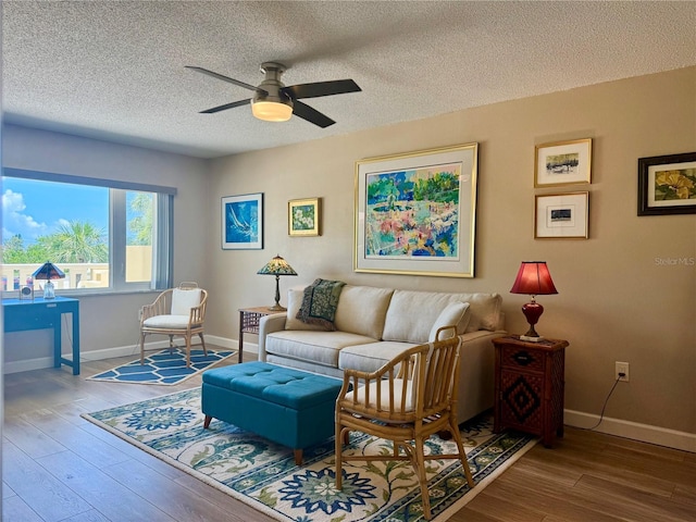 100 Bluff View Dr Unit 115C, Belleair Bluffs, FL 33770 - living room featuring a ceiling fan, wood finished floors, and a textured ceiling