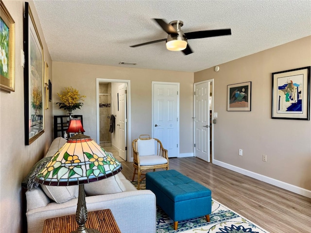 100 Bluff View Dr Unit 115C, Belleair Bluffs, FL 33770 - sitting room featuring ceiling fan, wood finished floors, and a textured ceiling