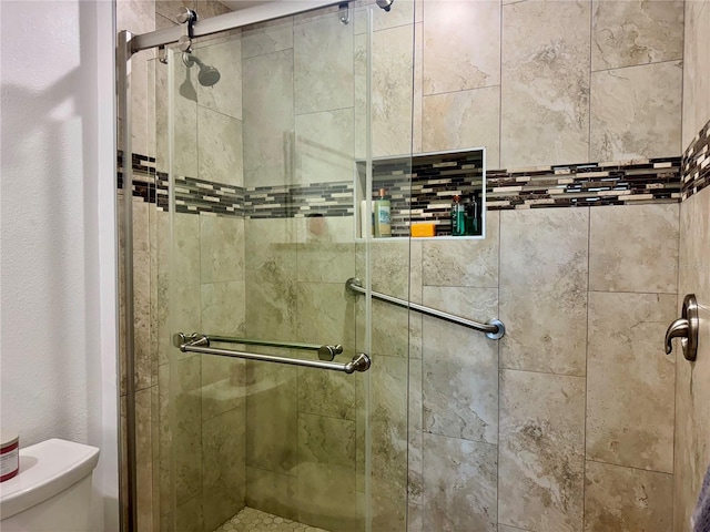 100 Bluff View Dr Unit 115C, Belleair Bluffs, FL 33770 - bathroom featuring toilet and a shower stall