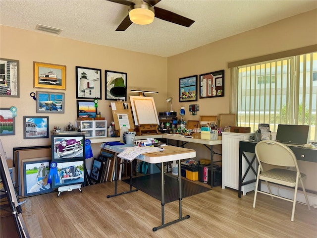 100 Bluff View Dr Unit 115C, Belleair Bluffs, FL 33770 - office featuring wood finished floors, a ceiling fan, and a textured ceiling