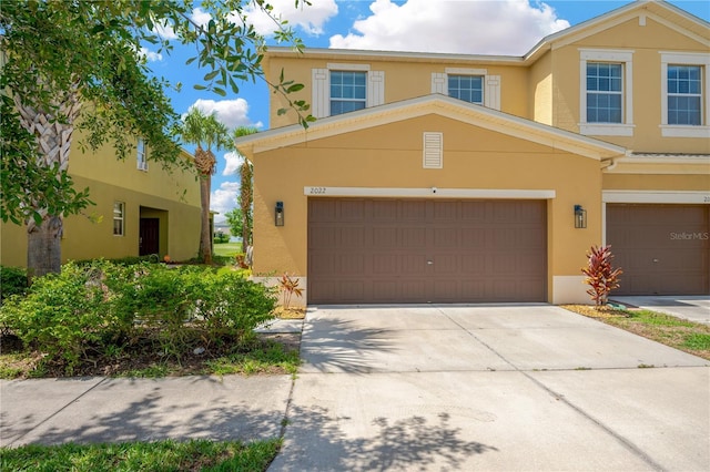 2022 Hawks View Dr, Ruskin, FL 33570 - view of front of property with stucco siding, concrete driveway, and an attached garage