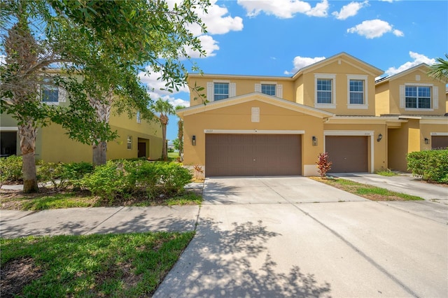 2022 Hawks View Dr, Ruskin, FL 33570 - townhome / multi-family property featuring stucco siding, driveway, and an attached garage