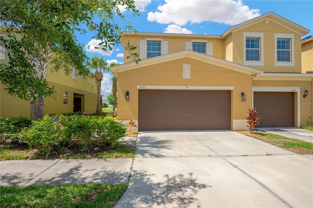2022 Hawks View Dr, Ruskin, FL 33570 - view of front of property featuring stucco siding, driveway, and an attached garage