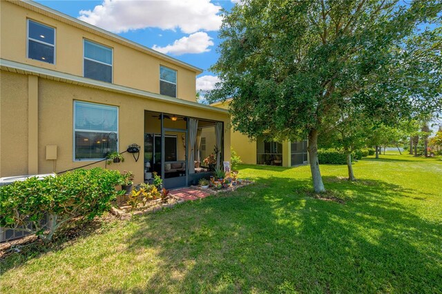 2022 Hawks View Dr, Ruskin, FL 33570 - view of grassy yard featuring a sunroom