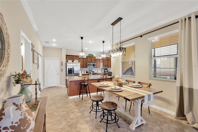 2022 Hawks View Dr, Ruskin, FL 33570 - dining area featuring ornamental molding, light tile patterned flooring, recessed lighting, and a chandelier
