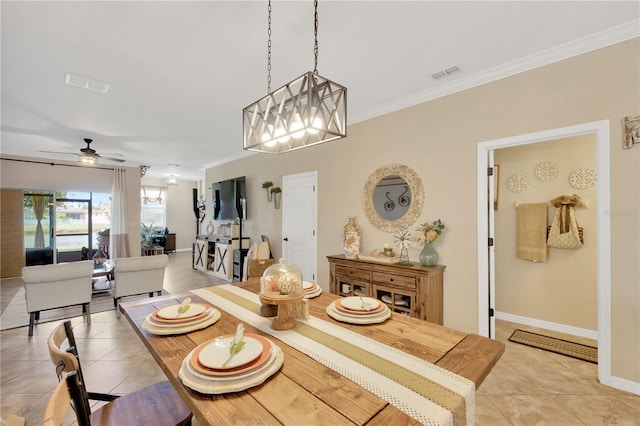 2022 Hawks View Dr, Ruskin, FL 33570 - dining room with light tile patterned floors, crown molding, a ceiling fan, and a chandelier