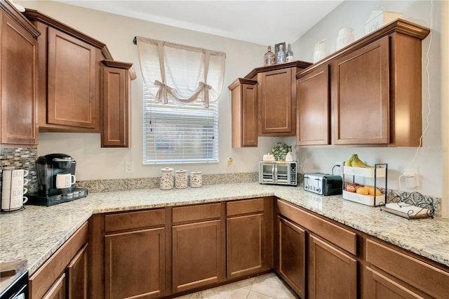 2022 Hawks View Dr, Ruskin, FL 33570 - kitchen featuring light stone counters and backsplash