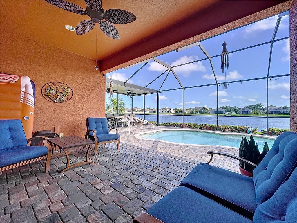 11614 Ashton Field Ave, Riverview, FL 33579 - swimming pool with a patio, a water view, a ceiling fan, and glass enclosure
