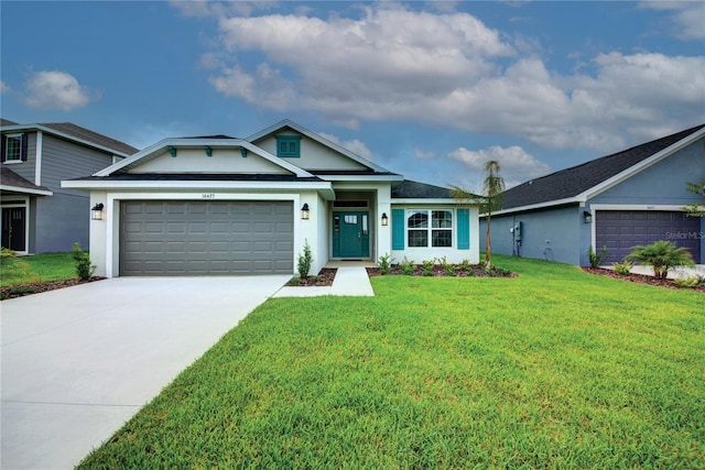 16425 66th Ln E, Parrish, FL 34219 - view of front of house featuring a front lawn, a garage, driveway, and stucco siding