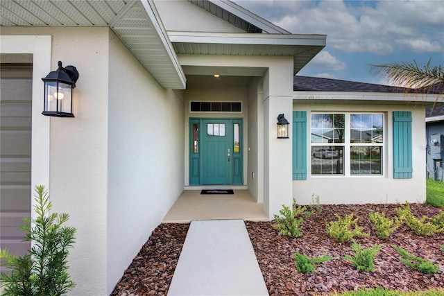 16425 66th Ln E, Parrish, FL 34219 - view of exterior entry with stucco siding and roof with shingles