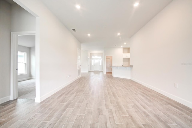 16425 66th Ln E, Parrish, FL 34219 - unfurnished living room featuring light wood finished floors, baseboards, and recessed lighting