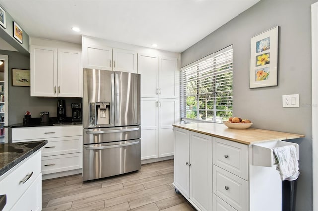 7219 4th Ave N, Saint Petersburg, FL 33710 - kitchen with stainless steel refrigerator with ice dispenser, white cabinets, light wood finished floors, and recessed lighting