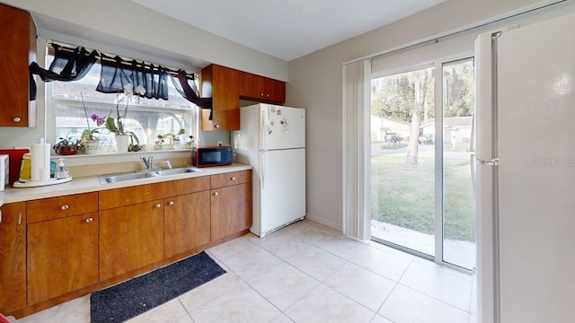 22798 Penny Loop, Land O Lakes, FL 34639 - kitchen with freestanding refrigerator, black microwave, light countertops, and a sink