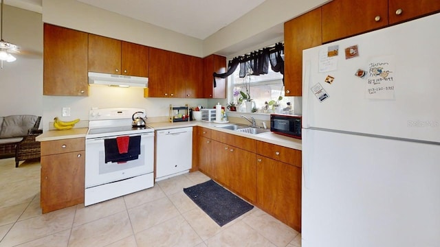 22798 Penny Loop, Land O Lakes, FL 34639 - kitchen featuring white appliances, under cabinet range hood, a sink, and light countertops