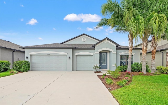 11434 Leland Groves Dr, Riverview, FL 33579 - view of front of home featuring stucco siding, a garage, driveway, and a front lawn