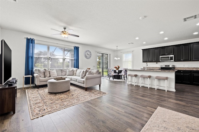 11434 Leland Groves Dr, Riverview, FL 33579 - living area featuring dark wood-style flooring, ceiling fan, recessed lighting, and a textured ceiling