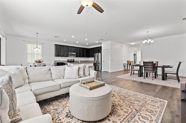 11434 Leland Groves Dr, Riverview, FL 33579 - living area with a chandelier, a ceiling fan, dark wood finished floors, and recessed lighting