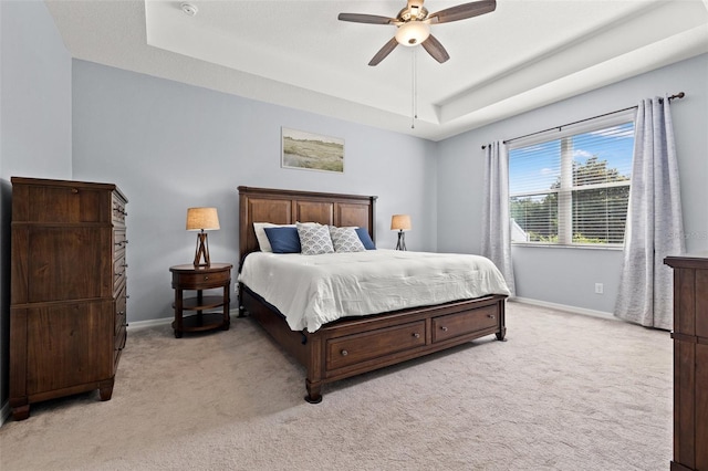 11434 Leland Groves Dr, Riverview, FL 33579 - bedroom featuring a raised ceiling, light colored carpet, and a ceiling fan