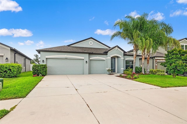 11434 Leland Groves Dr, Riverview, FL 33579 - view of front of home featuring stucco siding, a garage, a front lawn, driveway, and a shingled roof