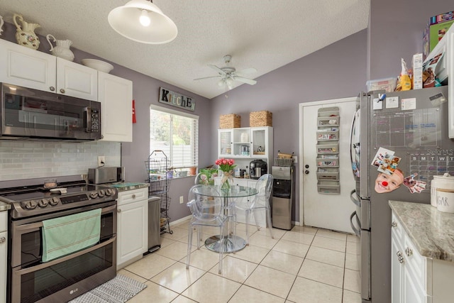 5826 Taywood Dr, Tampa, FL 33624 - kitchen featuring stainless steel appliances, vaulted ceiling, tasteful backsplash, ceiling fan, and white cabinets