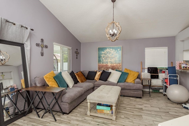 5826 Taywood Dr, Tampa, FL 33624 - living room with a chandelier, wood finished floors, vaulted ceiling, and a textured ceiling