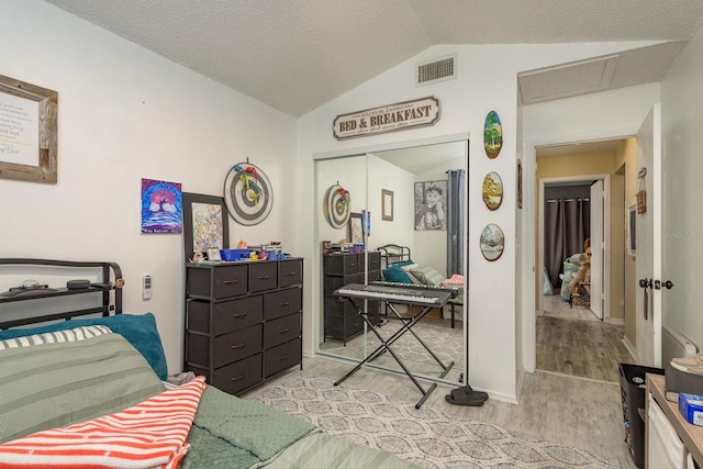5826 Taywood Dr, Tampa, FL 33624 - bedroom with light wood-style floors, lofted ceiling, attic access, a closet, and baseboards