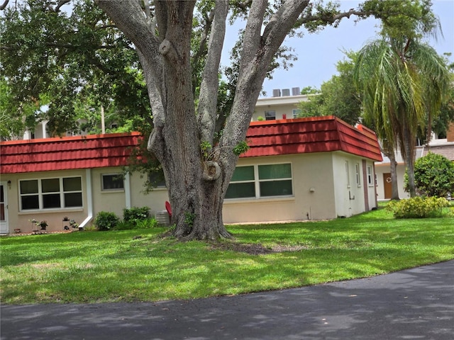 5865 37th Ave N Unit 26, Saint Petersburg, FL 33710 - front facade with stucco siding, a front lawn, and mansard roof